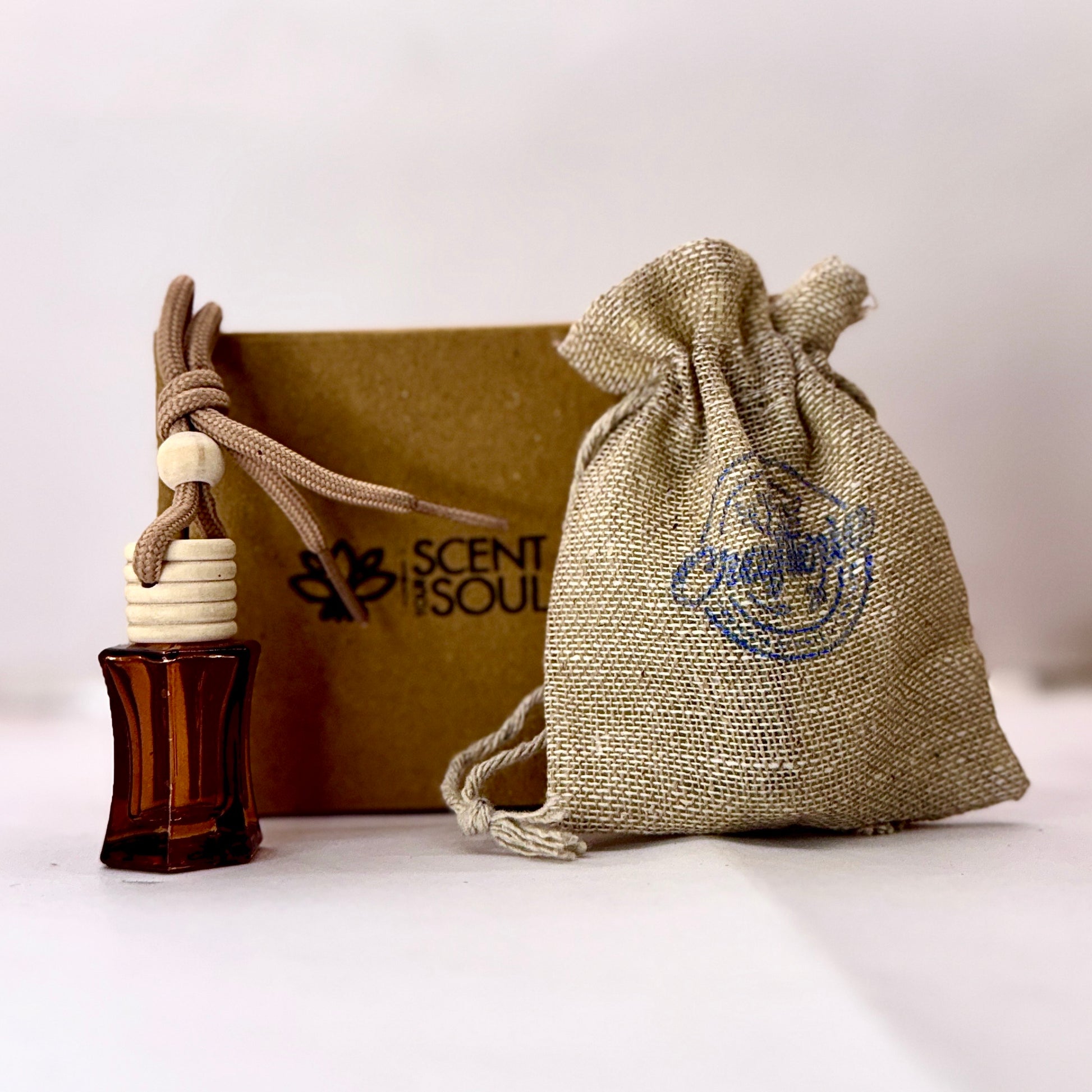 Curved Square Car Air Freshener in Glass Bottle comes with a jute bag and premium box