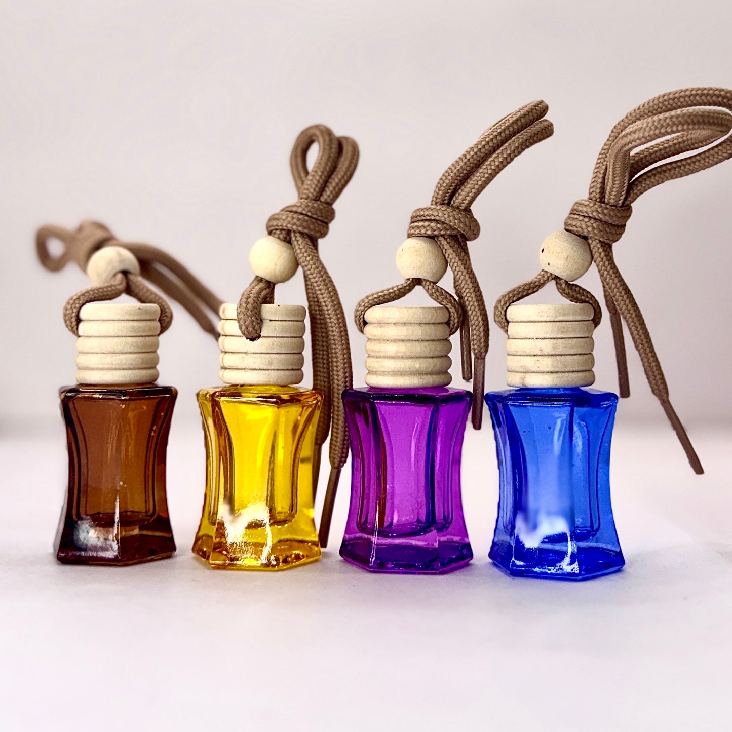 Aroma Hanging Car Perfume with Wooden Diffuser Cap  in Brown, Yellow, Purple and Blue